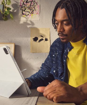 A man in an office setting using iPad Pro 12.9 inch, silver